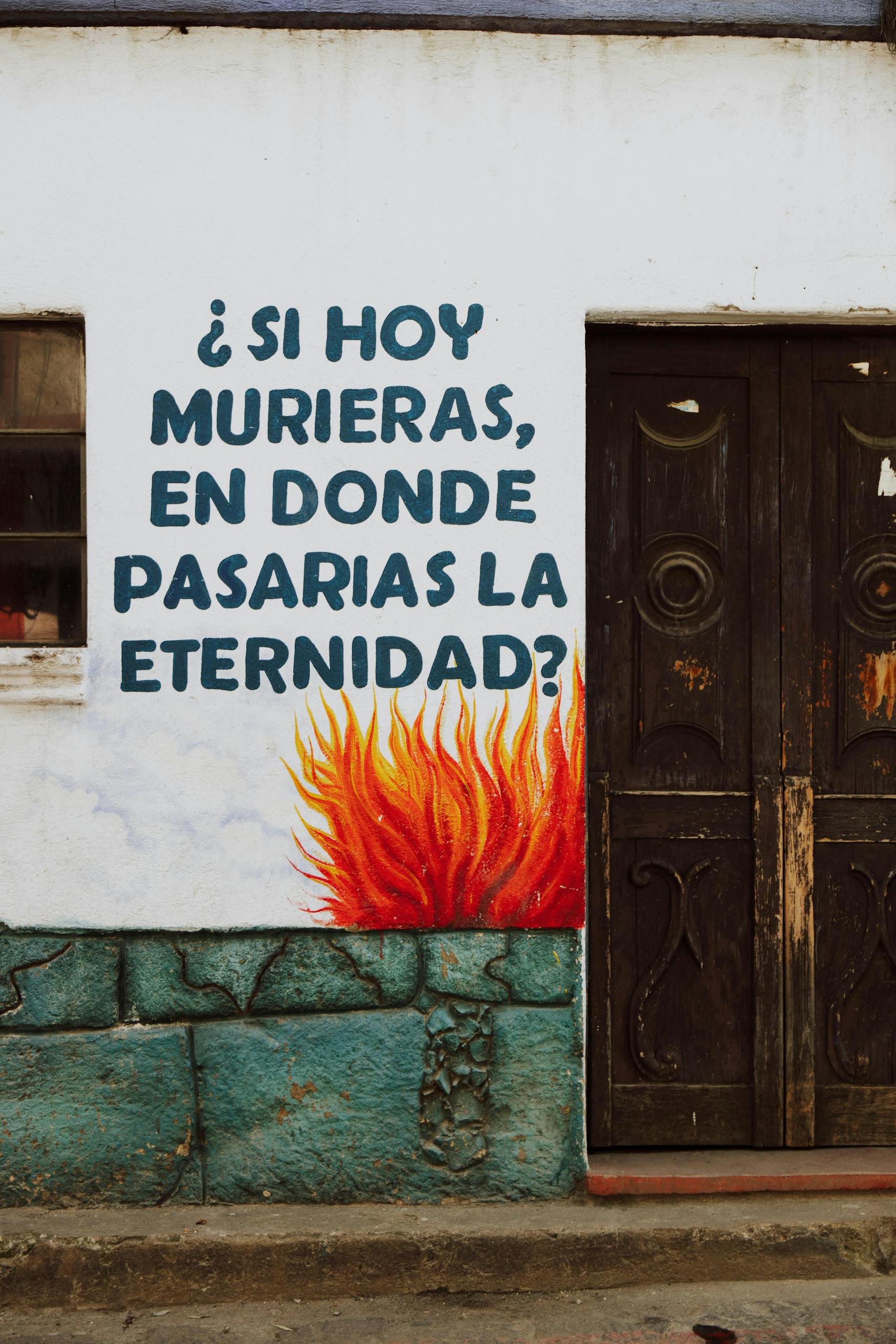 An old wooden door with eye-catching graffiti and text questioning eternity.